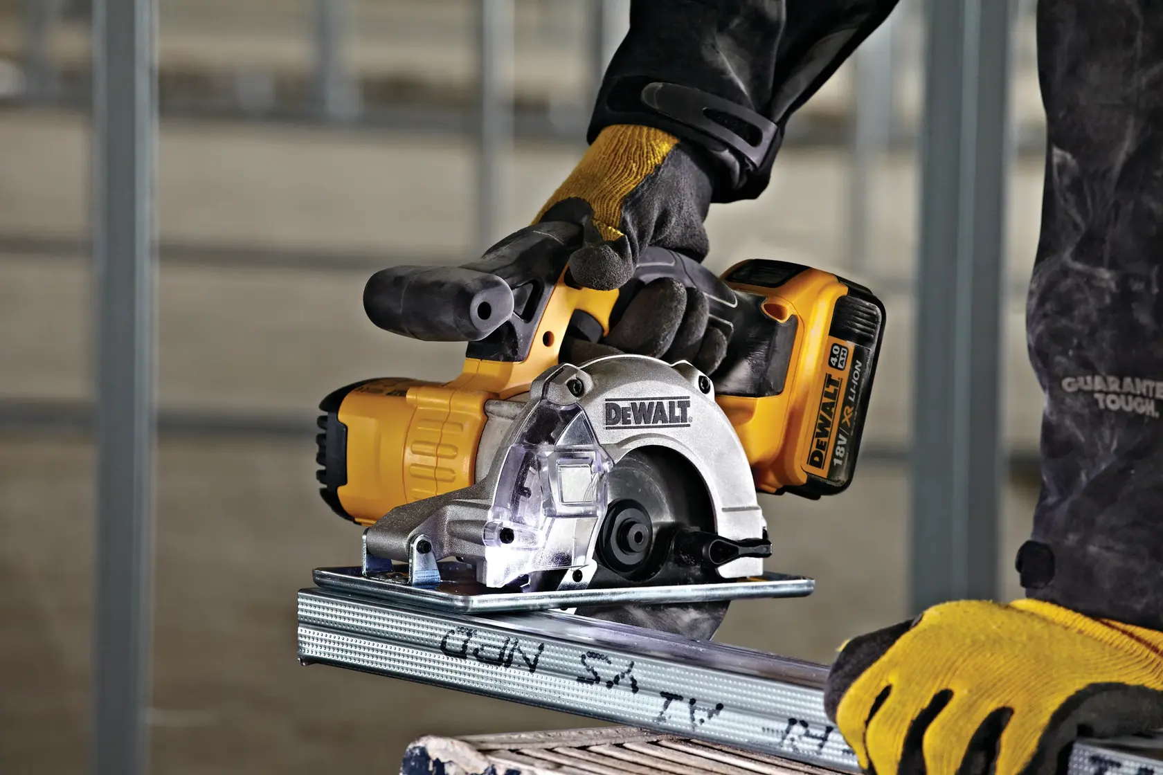 Photo of DEWALT cordless saw DCS373N-XJ, DCS373N in use, cutting metal, yellow-black tool, photography category.