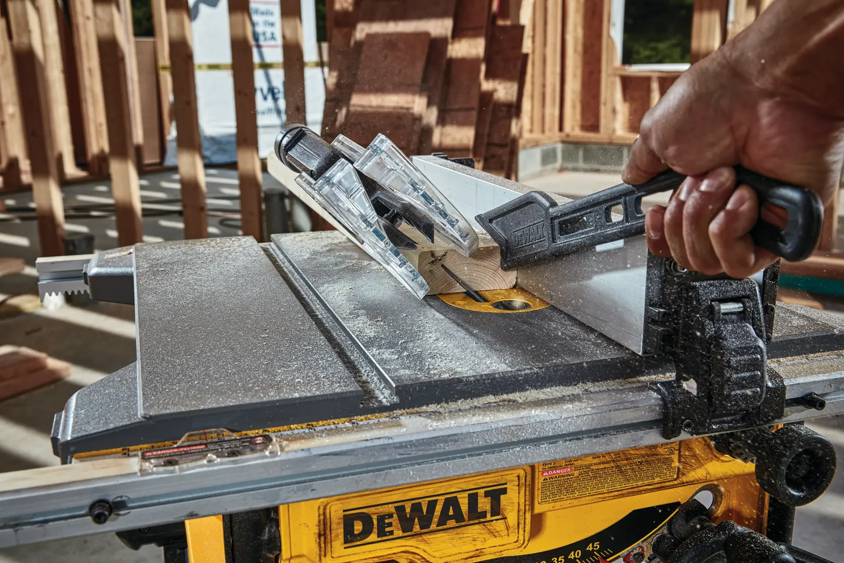 Photo of DEWALT table saw in use, SKUs DWE7485-GB, DWE7485-QS, DWE7485WS, DWE7485, cutting wood on jobsite.